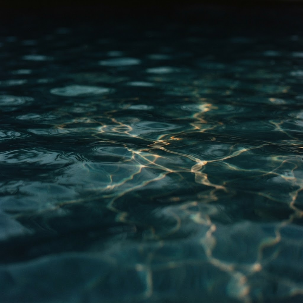 Close-up of calm turquoise pool water with soft reflections